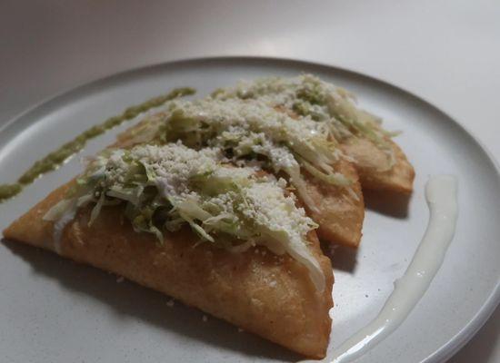 ORDER OF THREE EMPANADAS PREPARED WITH LETTUCE, COTIJA CHEESE, SOUR CREAM, CHOICE OF SAUCE