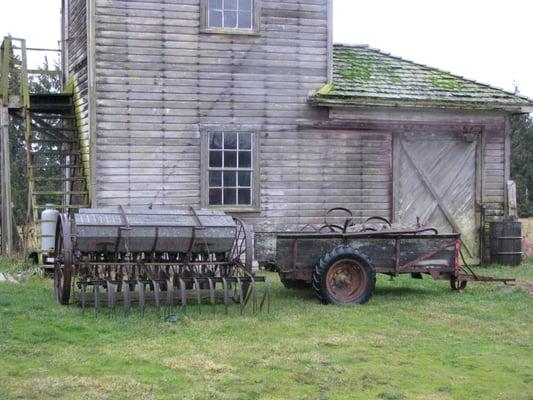 We love antique farm equipment, John Deere Van Brunt seeder on the left, Farm wagon on the right