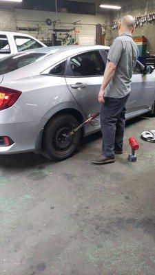 David putting my tire back on after patching it up.