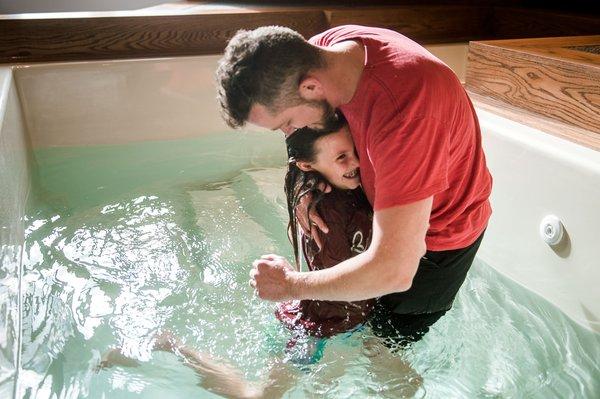 Dad and daughter share a moment during baptisms at Linworth Road Church in Columbus, Ohio.