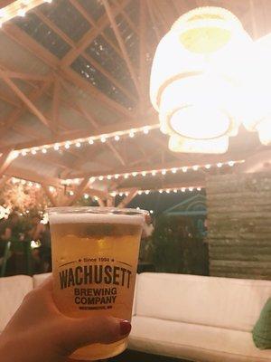 beautiful outdoor patio with beer on tap, cozy seating and dim lighting