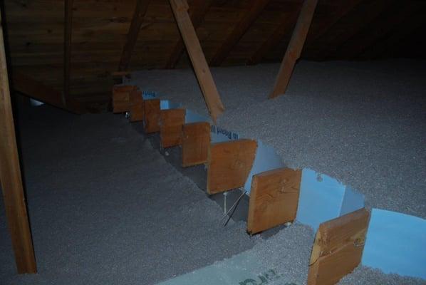 Attic dam wall insulation done the right way.