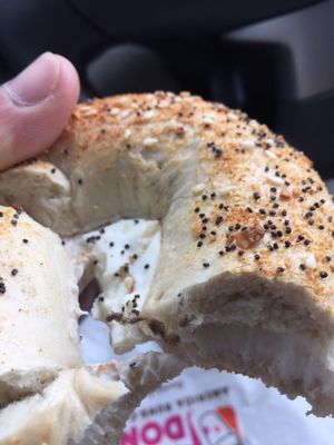 Everything bagel with cream cheese topped with lint/hair.