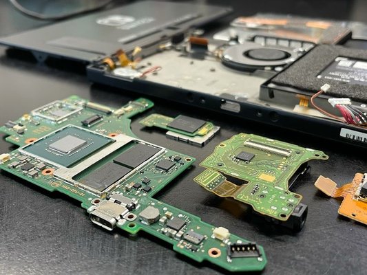 Nintendo Switch fully disassembled for a charge port replacement and cleaning.