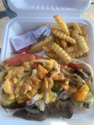 loaded beef cheese steak sandwich with fries