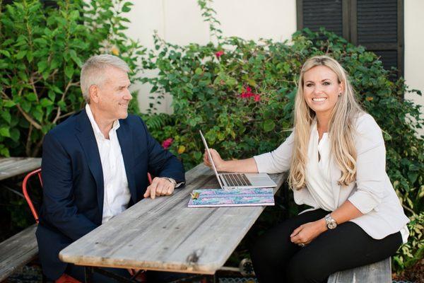 Holly Meyer Lucas and Harm Meyer discuss a real estate transaction at the Meyer Lucas office in Jupiter, Tequesta.