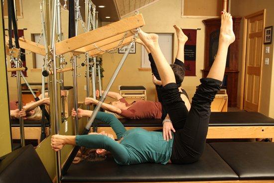 Duet class performing Tower on the Pilates Total Workout System .