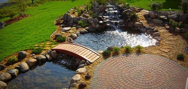 Waterfall with pond and walking bridge.