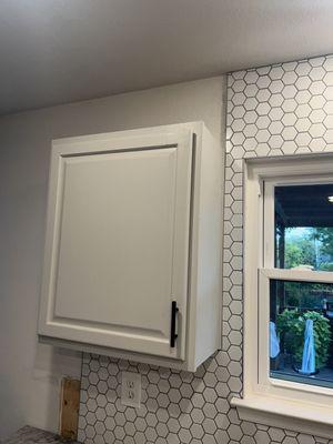 Unfinished cabinets and backsplash