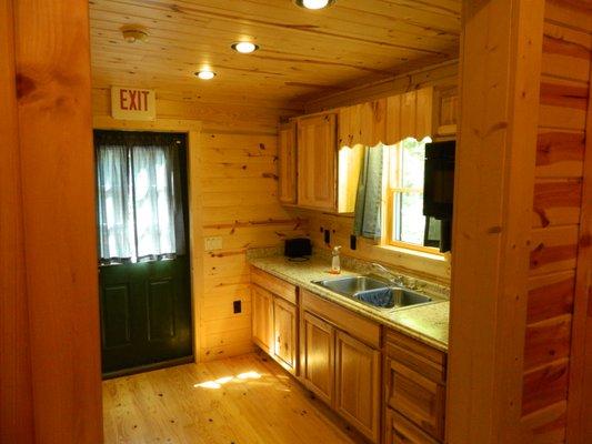 Inside rear view of cabin with back kitchenette