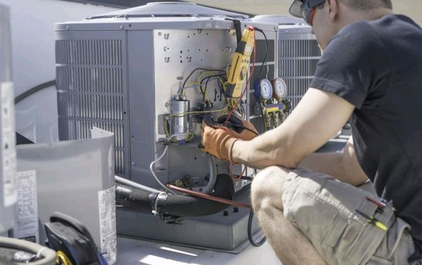 This technician is servicing a air conditioning unit.