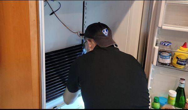 Technician working on a subzero refrigerator