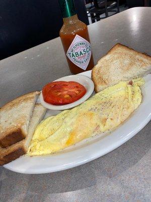 Ham and cheese omelette with sliced tomatoes