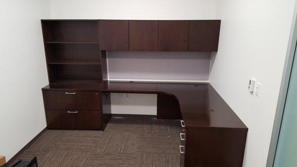 Wall to wall desk and cabinets.