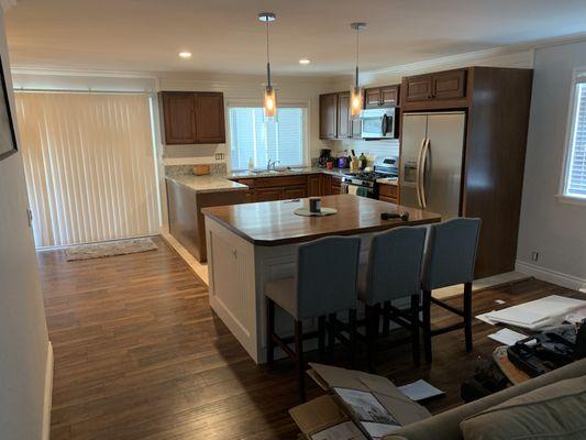 Kitchen remodel consisting of removing a wall, and adding an island and new lighting.