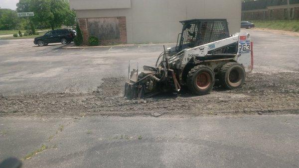 we are grinding out the bad spots of a parking lot with a milling machine