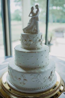 Almond-flavored wedding cake with buttercream icing and white-chocolate fleur de lis.