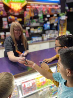 Employee helping guests at prize counter