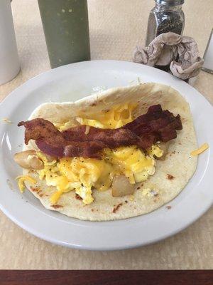 Potato egg bacon and cheese taco. Love the breakfast tacos here!