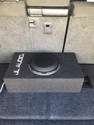 JL audio sub. Small but clean sounds. Fits behind my 3rd row when I need to open em up.