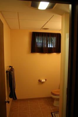 After the remodel bathroom has a new tile baseboard and tile floor. New drop ceiling and vent/heat/ light fan.