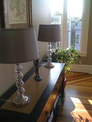 Asian-style console with marble inlayed top.  Crystal lamps with silver shades