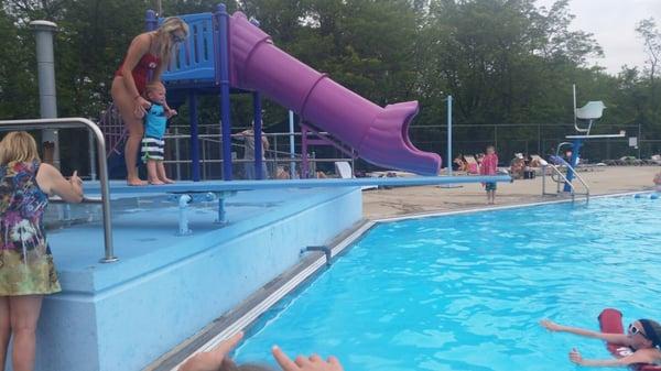 Diving board and slide. Trying to jump off the diving board.