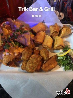 The Sampler (pick any 3 items from the starting line) Shown: Egg rolls, Stuffed jalapeños, and our popular stuffed nachos