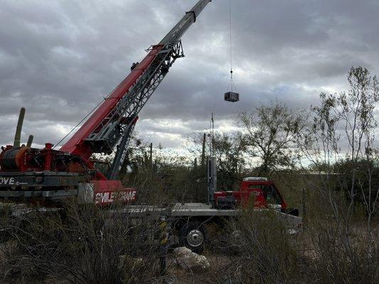 Crane loading a old ac unit in Tucson