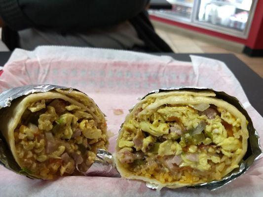 Breakfast burrito with ham, beans, rice, cheese, cilantro, jalapenos and rice added.