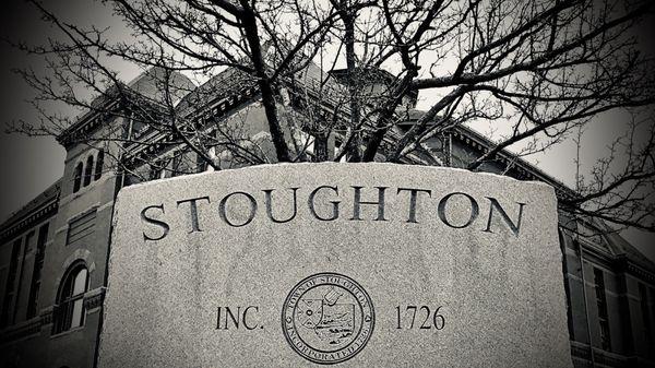 The engraved stone marker which sits in front of Stoughton Town Hall