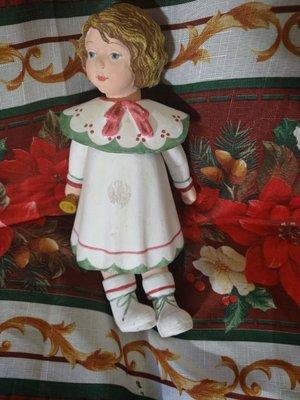 A wooden doll with rubber band head, legs an arms.