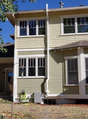 Close up of green home with radon mitigation system installed