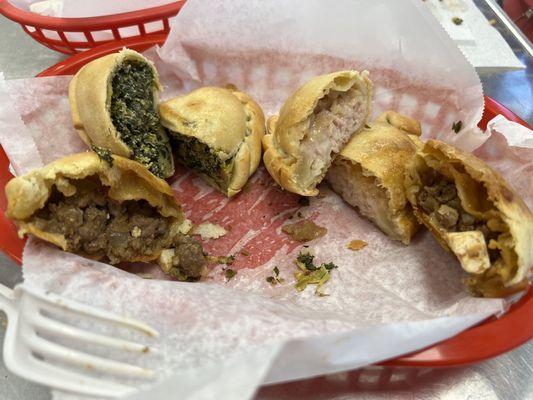 Empanadas - sliced in half to show filling. Spinach, chicken and beef.