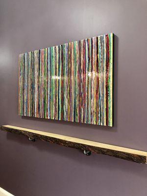 Artwork and live edge wooden shelf.