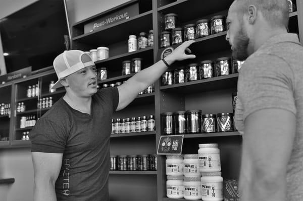 Josh consulting with a customer on different pre workouts.