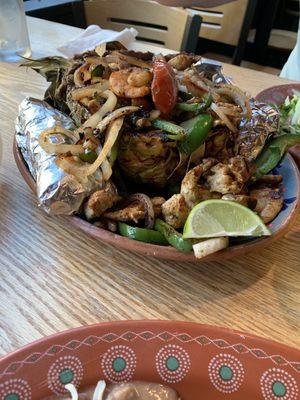 Pineapple boat with steak, chicken, shrimp and veggies.