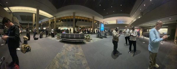 People waiting in line with one agent at the counter.