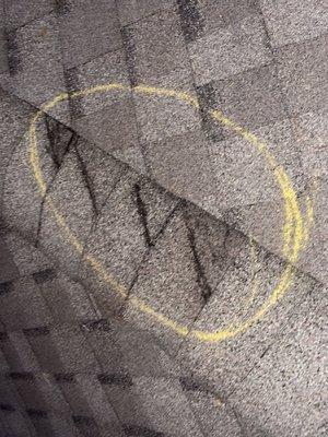 Roof shingle from ridge cap damaged from hurricane winds