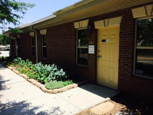 We grow vegetables and herbs in the planting beds at our front office doors.