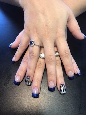 These are nails Launa did. She gave the young lady a fill, polished with a beautiful blue color, and some nail art.