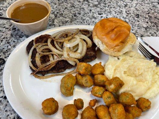 Hamburger steak with grilled onions and gravy on the side.  Mashed potatoes and fried okra and roll.  SO GOOD!