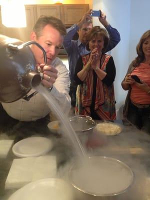 Steve is carefully pouring liquid nitrogen to use for cold fondue. What great fun!