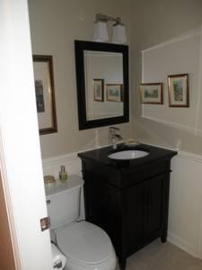 Complete half bath redo new vanity, toilet, paneling, tile, lights..