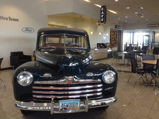 Cafe entrance - passing a pristine Ford Woody Station Wagon.