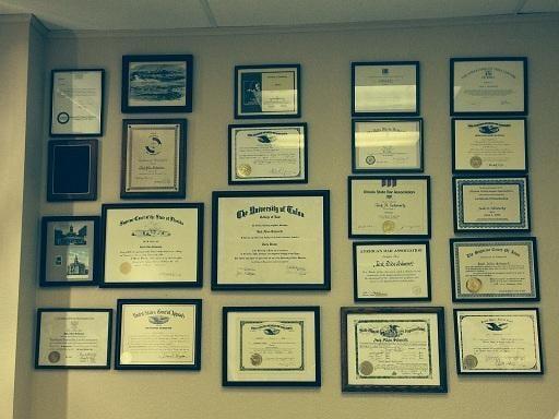 Wall of honors and diplomas in Jack's office.