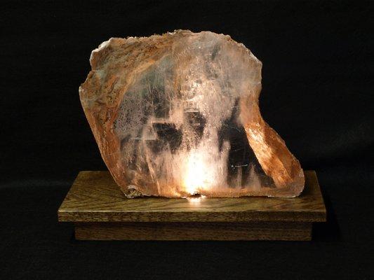 Lighted base with Selenite slab with clay highlights.