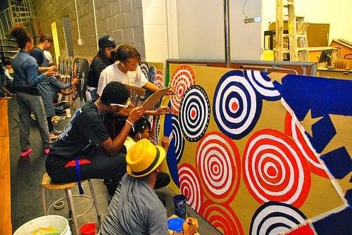 Students from Brazil and U.S. painting mural at Suitland High School