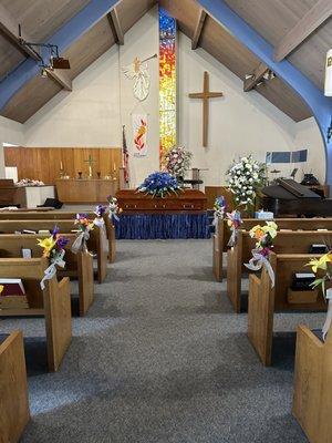 Viewing with Cremation Wood Rental Casket with Blue flowers.