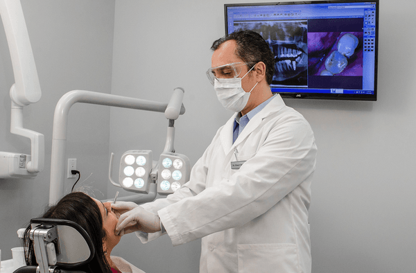 Dr. Eduart Shkurti working on a dental patient